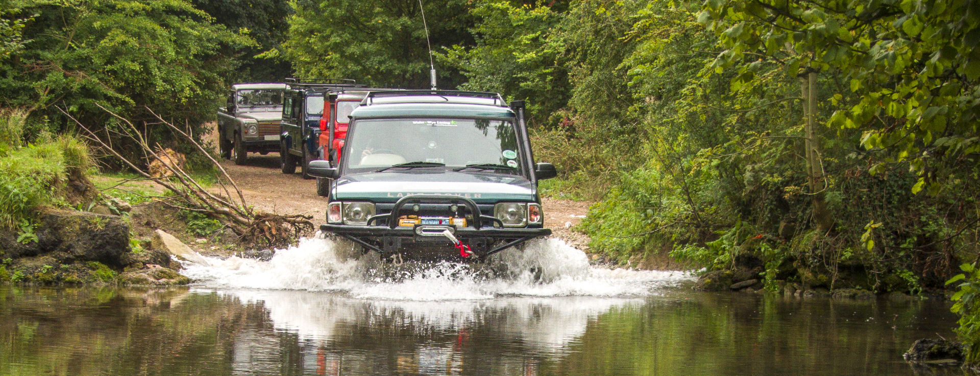 Group of 4x4 fording a river