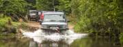 Group of 4x4 fording a river